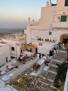 people sitting at tables on the roof of a building