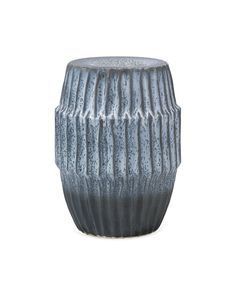 a gray vase sitting on top of a white table