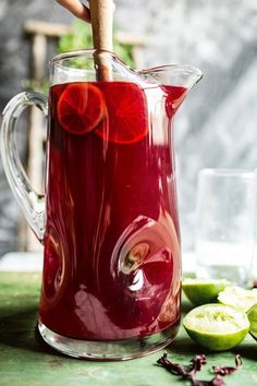 a pitcher filled with liquid sitting on top of a table