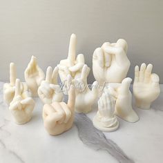 a group of white sculptures sitting on top of a marble counter