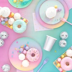 a table topped with plates and cups filled with donuts