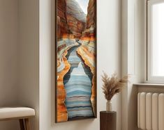 a painting hanging on the wall next to a radiator in a living room