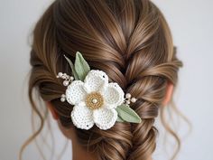 a close up of a woman's hair with a flower in it