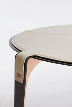 a close up of a table with a white top and black frame on the bottom