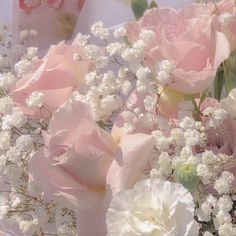 some pink and white flowers on a table