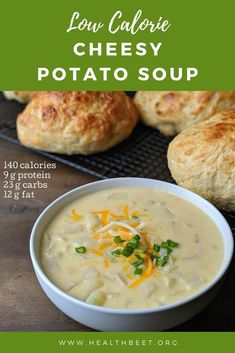 a bowl filled with soup next to croissants