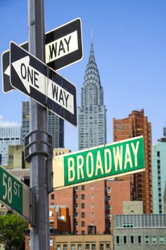 the street signs are clearly visible for all to see in this photo, including one way and broadway