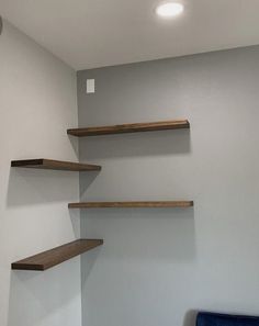 an empty room with some shelves on the wall