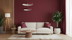 a living room with red walls, white furniture and potted plants on the floor