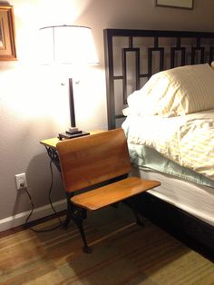 a wooden chair sitting in front of a bed