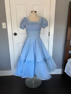 Absolutely lovely 1940's/50's baby blue super full circle skirt dress with tulle ruffles. Metal side zipper, short puffy sleeves. Great vintage condition and ready to wear! Womens small Measurements coming Blue 1950s Dress, Vintage Full Skirt Dress With Ruffles, Vintage Light Blue Ruffled Dress, Vintage Light Blue Dress With Ruffles, Light Blue Vintage Dress With Ruffles, Vintage Short Sleeve Dress With Ruffles, 1950s Ruffled Vintage Dress, 1950s Vintage Dress With Ruffles, 1950s Style Vintage Dress With Ruffles