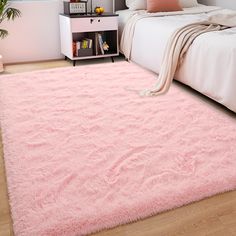 a bedroom with a pink rug on the floor