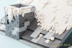 a close up of a lego model of a building made out of white and gray bricks