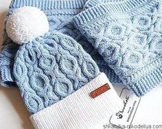 a blue knitted hat with a white pom - pom