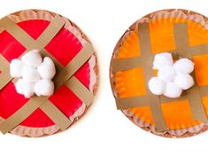 two paper plates that have cotton balls on them, one is orange and the other is brown