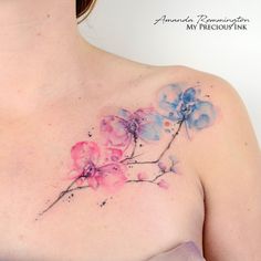 a woman's chest with pink and blue flowers painted on the side by watercolor pencils