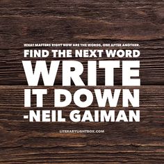 a wooden wall with the words, find the next word write it down neil gaiman