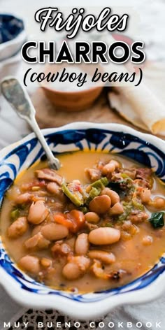 a bowl filled with beans and broccoli on top of a blue and white plate