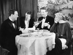 a group of people sitting around a dinner table