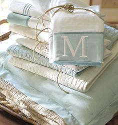 a stack of folded towels with the letter m on them