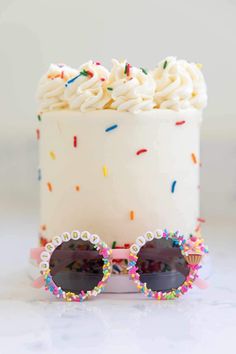 a cake with sprinkles and sunglasses on it