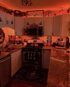 the kitchen is decorated for halloween with decorations on the counter top and lights in the ceiling