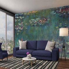 the living room is decorated in blue and has a large painting on the wall behind it