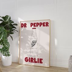 a poster with the words dr pepper on it next to a potted plant