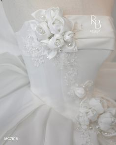 the back of a wedding dress with flowers on it