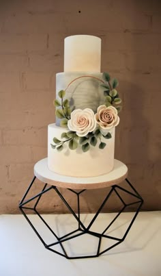 a three tiered cake with flowers on top