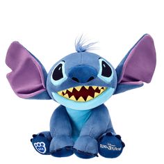 a blue stuffed animal with an open mouth