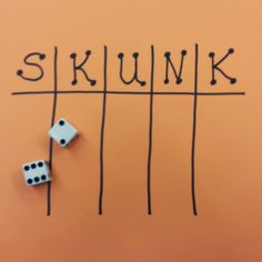 two dices sitting on top of each other near the word skunk