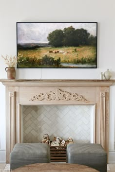 a painting on the wall above a fireplace in a living room