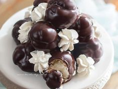 a white plate topped with lots of chocolate covered candies and marshmallows