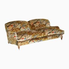 an old fashioned couch with birds on it's back and arms, against a white background