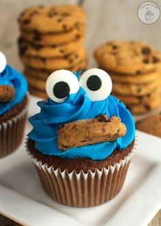 a cupcake with blue frosting and googly eyes sitting on top of a plate