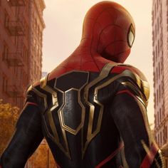 the amazing spider - man stands in front of some tall buildings and looks into the distance