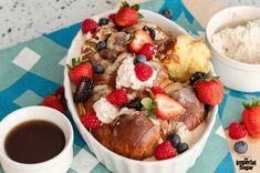 a cake with strawberries, blueberries and other toppings