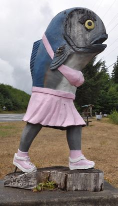 a statue of a fish wearing a pink dress