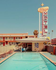 a motel with a swimming pool in front of it