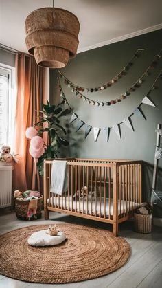 a baby's room with a wooden crib, rug and hanging bunting