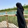 a person standing on a bridge looking at the water