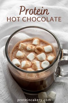 hot chocolate in a glass mug with marshmallows on top and text overlay