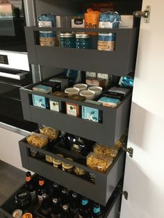 the shelves are filled with different types of food and drinks in their storage bins