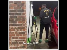 a man is pumping gas into his car