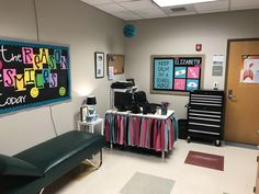 an office with desks, chairs and posters on the wall