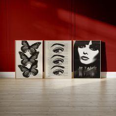 three black and white paintings on wooden floors in front of a red wall with butterflies