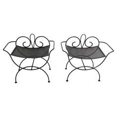 pair of wrought iron planters on stands