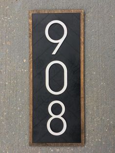 a black and white sign with the number 990 on it's back side