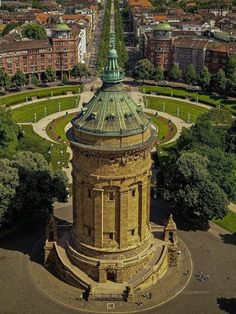 an aerial view of a large building in the middle of a park with lots of trees